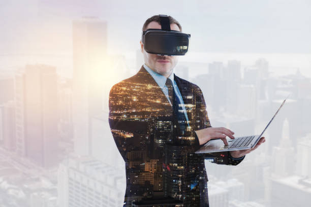 istock Young businessman in VR headset holding laptop 862634800