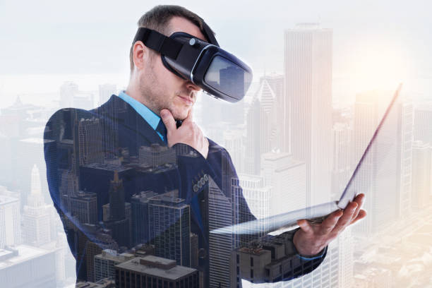istock Bristled businessman in VR headset reading from laptop 862636468