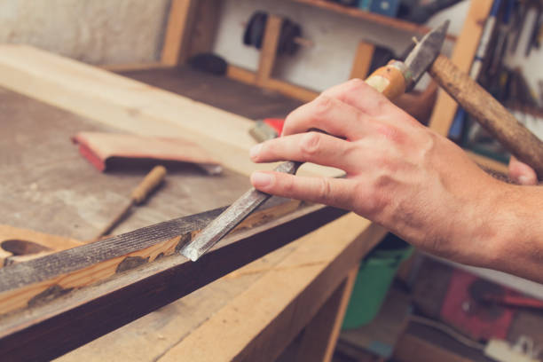 istock Male carpenter working on raw wood / boards / plank. 862637690