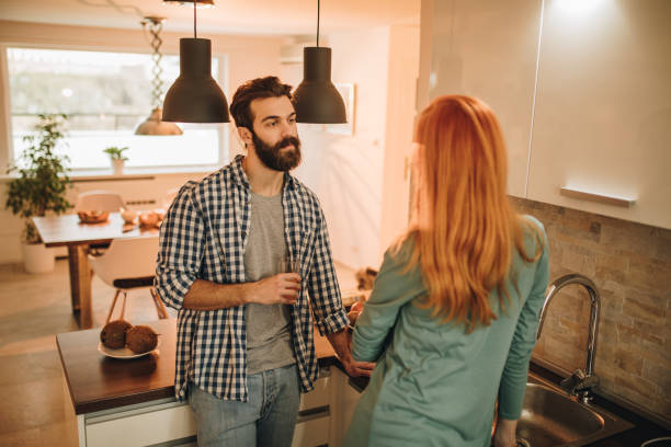 istock Young man standing in the kitchen and communicating with his girlfriend. 862638492