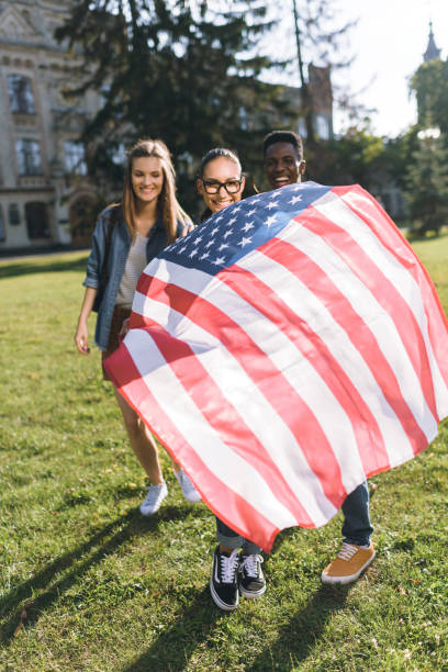 istock multicultural friends with american flag 862641388