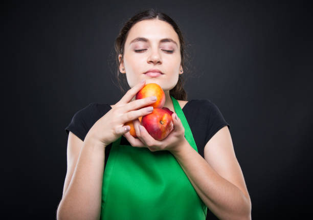 istock Young woman smelling some fresh and sweet nectarines 862641878