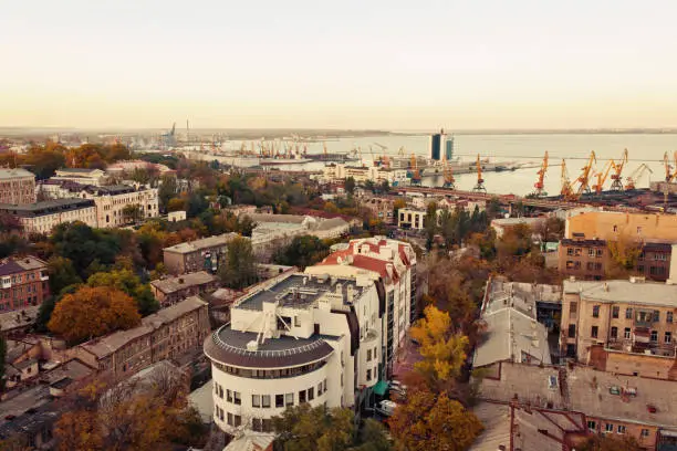 aerial view to Odessa, roofs, port and sea at sunset