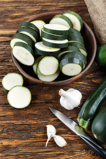 istock zucchini sliced and whole zucchini lying on the board. 862648496