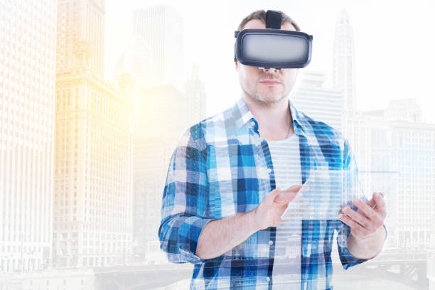 istock Bristled man in VR headset and tapping on tablet 862650266