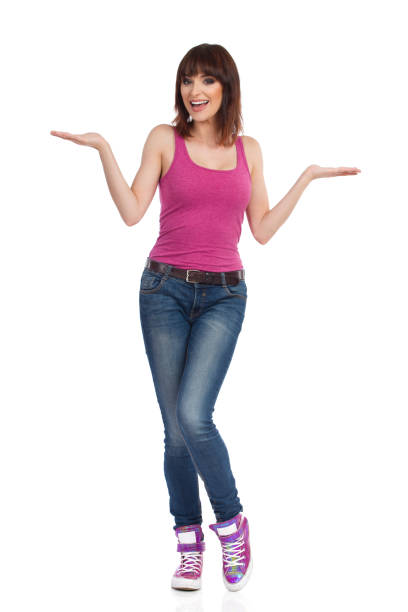 istock Smiling Young Woman Is Presenting With Hands Raised 862650328