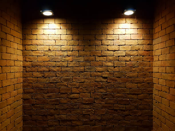 istock abstract old brick wall in the dark with two spotlight, warm light tone. brick wall in empty room. brick wall background for wallpaper 862657142