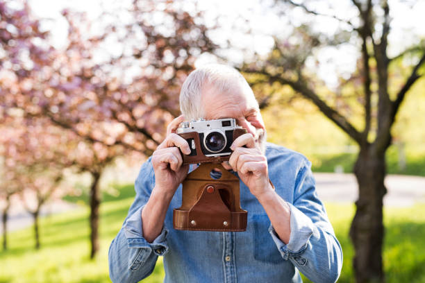 istock Senior man outside in spring nature taking pictures. 862657390
