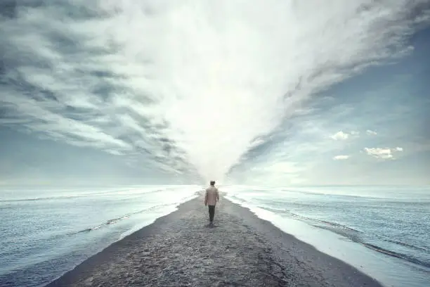 Photo of man walking between two seas