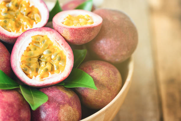 istock Close up fresh passion fruit in wood bowl on wood table in side view with copy space for background or wallpaper. Ripe passion fruit so delicious sweet and sour. Tropical fruit. Macro concept. 862663656
