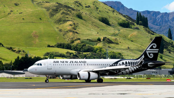 Airplane of Air New Zealand takes off from airport stock photo