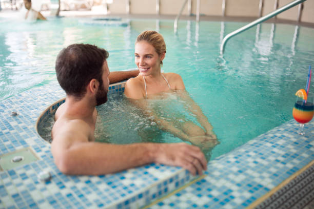istock Cheerful happy couple relaxing in swimming pool 862667108