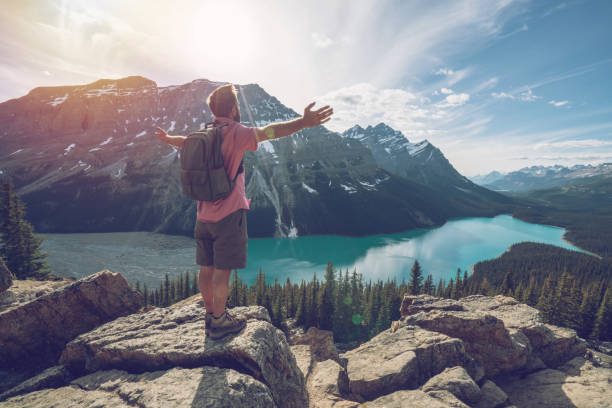 istock Hiker male reaches mountain top, arms outstretched 862667324