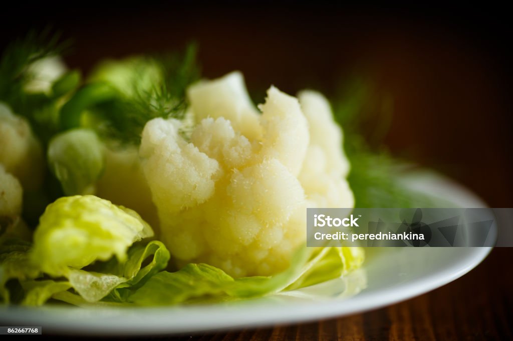 cauliflower with salad leaves cauliflower with salad leaves on a wooden table Appetizer Stock Photo