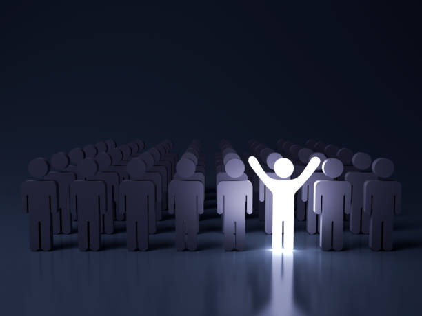 Stand out from the crowd and different creative idea concepts , One glowing light man standing with arms wide open among other people in the row on dark blue background with reflection . 3D rendering stock photo