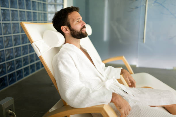istock Handsome man relaxing in chair at spa center 862671196