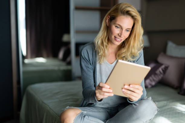 istock Portrait of blond beautiful woman using tablet 862671380