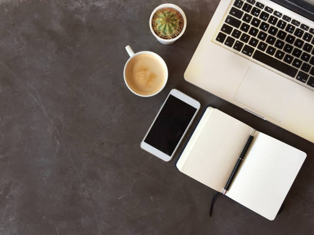 istock Top view of office desk on dark textured background 862671686