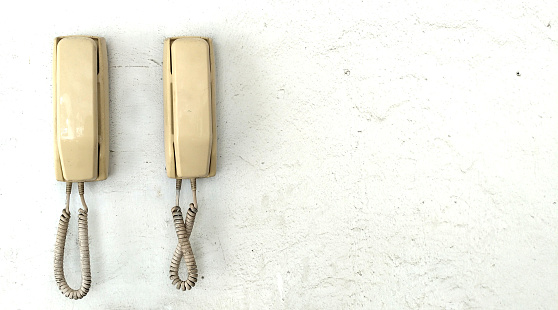 Old and vintage telephone on the wall.