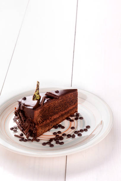 istock Small cake with different stuffing on a white plate. White wooden table 862675174