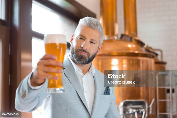 The Microbrewery Owner Holding A Beer Glass In His Pub Stock Photo - Download Image Now