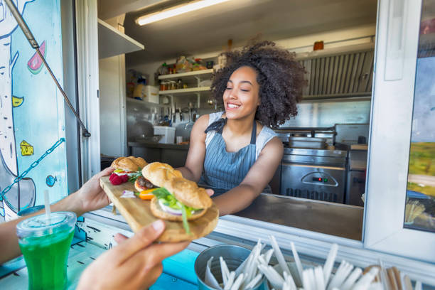 istock Female food van worker giving order to customer 862686184