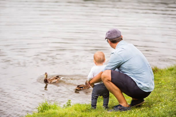istock Father and the son by the lake in summer. 862688152