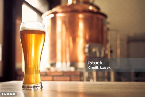 Glass Of Lager Beer In Front Of Copper Vat Stock Photo - Download Image Now - Brewery, Beer - Alcohol, Craft Beer
