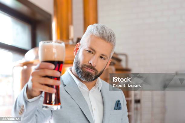 The Microbrewery Owner Holding A Beer Glass In Pub Stock Photo - Download Image Now - Adult, Adults Only, Alcohol - Drink