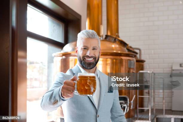 Happy Elegant Man Holding A Beer Mug In Microbrewery Stock Photo - Download Image Now