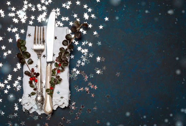 istock Christmas cutlery and table place setting, holidays copy space fairy light toning background 862689030