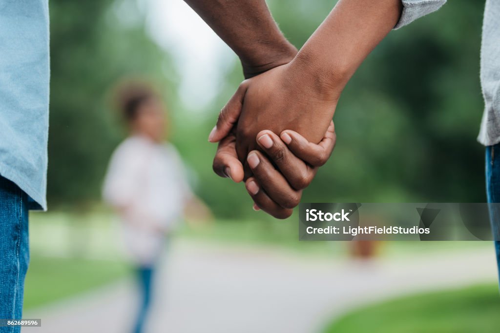 couple holding hands cropped shot of african american couple holding hands Holding Hands Stock Photo