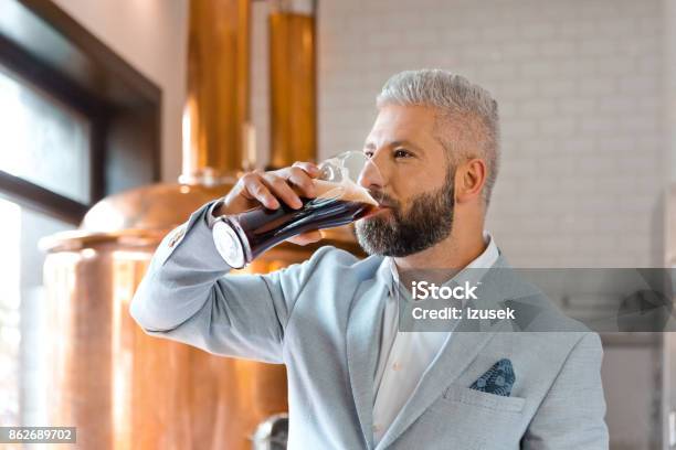 The Microbrewery Owner Drinking Ale Beer In His Pub Stock Photo - Download Image Now