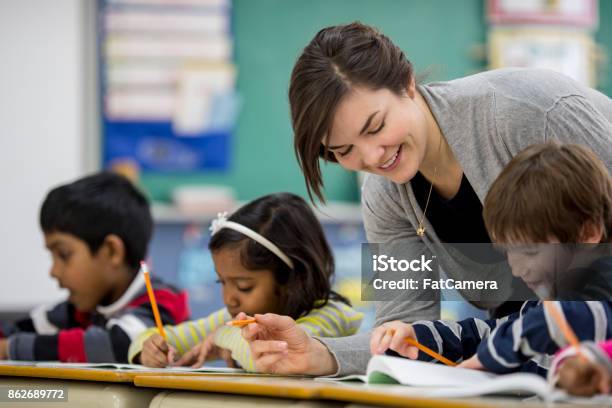 Getting Help Photo Getting Help Stock Photo - Download Image Now - Classroom, Girls ...