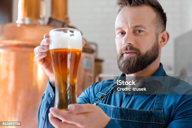 The Master Brewer Holding Beer Glass In His Micro Brewery Stock Photo - Download Image Now