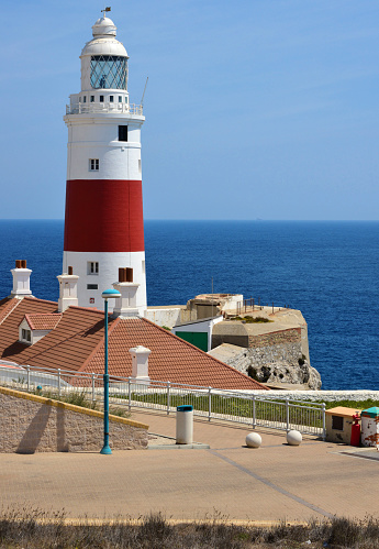 Gibraltar: roofs and the red and white striped of Europa Point Lighthouse, aka Trinity Lighthouse, Victoria Tower or La Farola - Strait of Gibraltar - photo by M.Torres