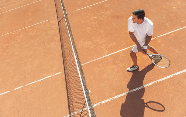 istock Man playing tennis on court 862699650