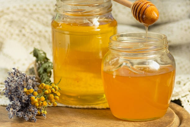 istock Honey in the glass jar is beside the attributes 862699708