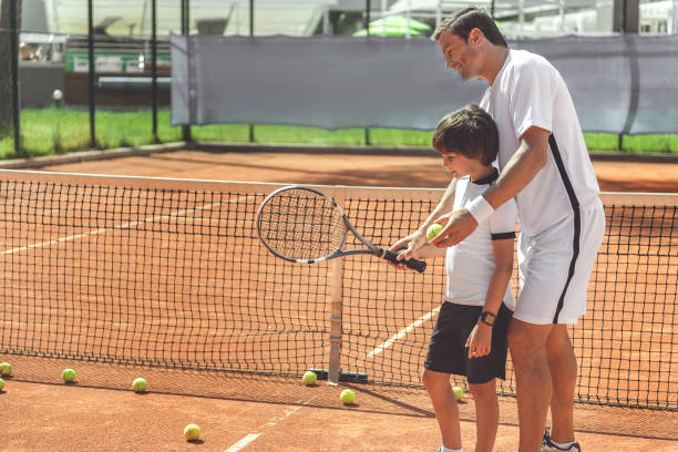 istock Glad father teaching son at court 862700018
