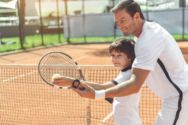 istock Trainer teaching boy to play tennis 862700116