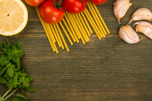 istock Raw Italian Cooking Ingredients Including Pasta Spaghetti Garlic and Vine Tomatoes 862703688
