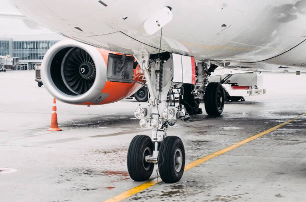 istock Front landing gear and engine airplane parking in the airport. 862704318