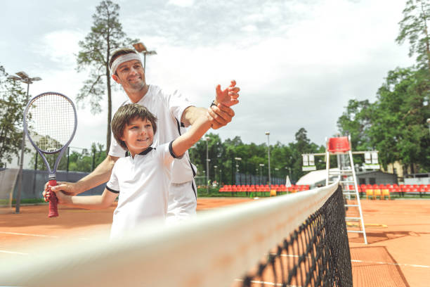 istock Joyous smiling family playing tennis 862704364