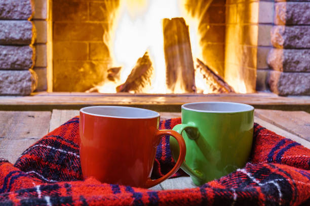 istock Two  mugs  for tea or coffee,  wool things near  cozy fireplace. 862704724