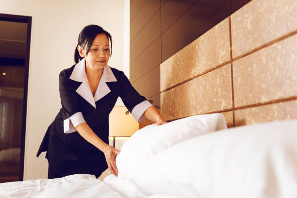 istock Serious maid putting pillow straight 862707018