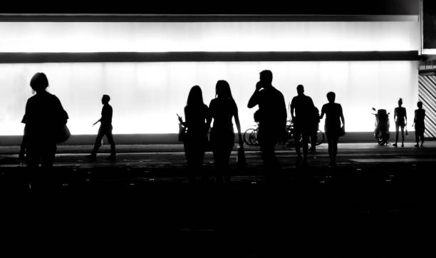 Blurry silhouettes of people in the night