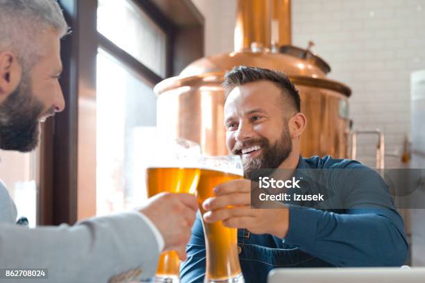 Brewer Master Toasting With Beer Glass With His Friend Stock Photo - Download Image Now