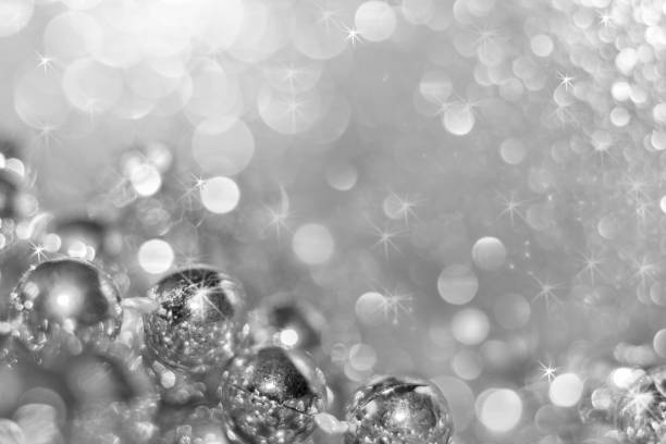 istock Abstract silver christmas black and white background with soft focus. Round beads on the bottom left and beautiful bokeh with asterisks. 862708640