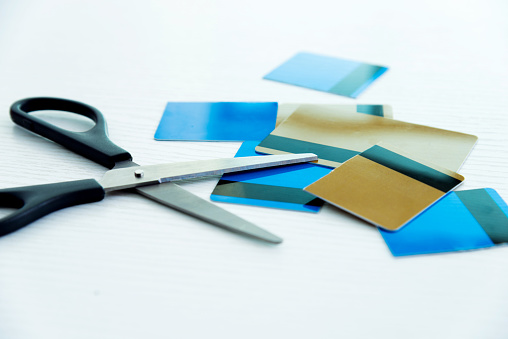 Scissors cutting credit cards.