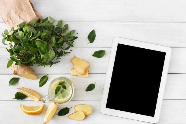 istock Detox lemonade smoothie ingredients, top view on white with tablet 862716734